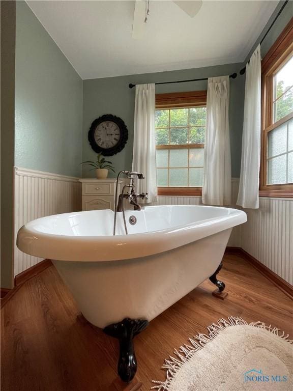 706 Grandview Ct, Elmore, OH 43416 - bathroom featuring wood finished floors, wainscoting, and a soaking tub