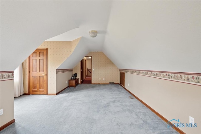 706 Grandview Ct, Elmore, OH 43416 - bonus room featuring wallpapered walls, vaulted ceiling, and carpet floors