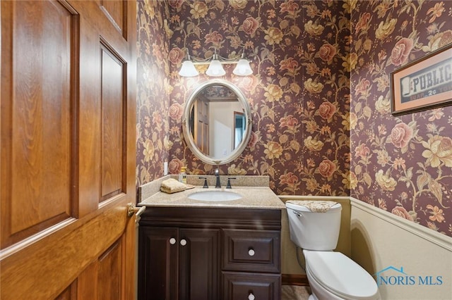706 Grandview Ct, Elmore, OH 43416 - bathroom featuring wallpapered walls, wainscoting, and vanity