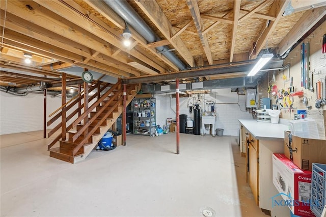 706 Grandview Ct, Elmore, OH 43416 - unfinished below grade area featuring stairway, a workshop area, and electric panel