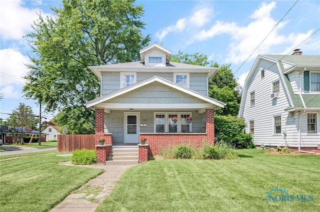 3162 Glanzman Rd, Toledo, OH 43614 - traditional style home with a porch, a front lawn, and brick siding