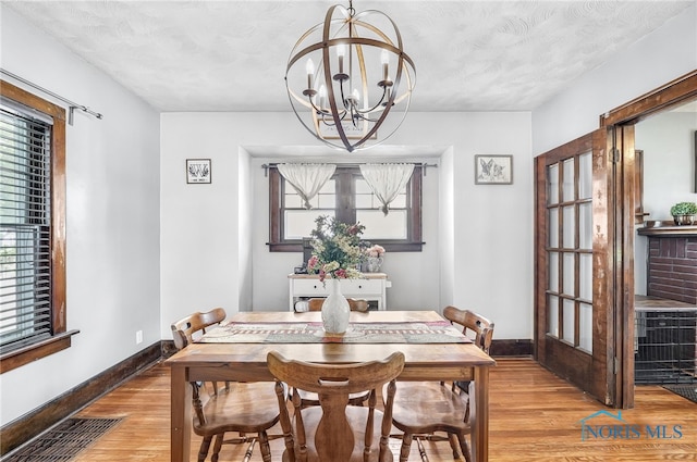 3162 Glanzman Rd, Toledo, OH 43614 - dining room featuring wood finished floors and a chandelier