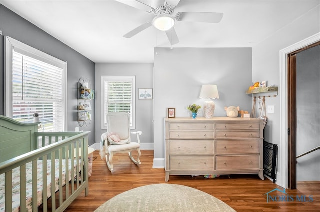 3162 Glanzman Rd, Toledo, OH 43614 - bedroom with wood finished floors, a ceiling fan, and a nursery area