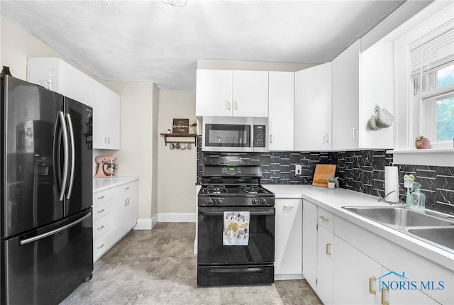 3162 Glanzman Rd, Toledo, OH 43614 - kitchen featuring freestanding refrigerator, stainless steel microwave, gas stove, and backsplash