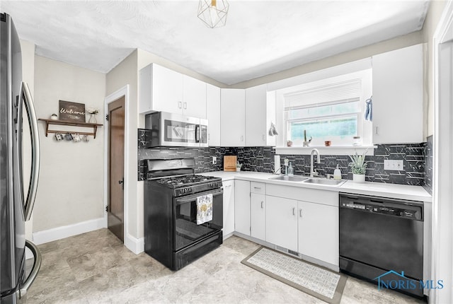 3162 Glanzman Rd, Toledo, OH 43614 - kitchen featuring black appliances, light countertops, backsplash, and white cabinets