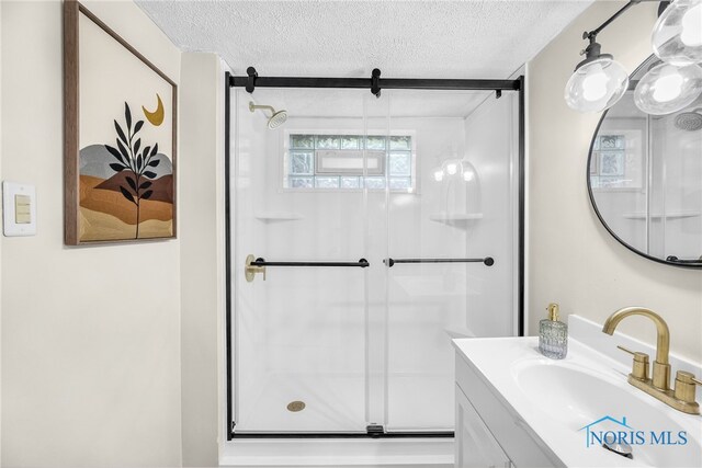 3162 Glanzman Rd, Toledo, OH 43614 - bathroom featuring a textured ceiling, vanity, and a stall shower