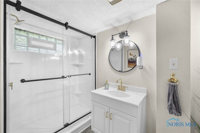 3162 Glanzman Rd, Toledo, OH 43614 - bathroom featuring a textured ceiling, vanity, and a shower stall