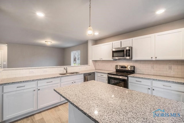 1492 Lee Ann Ave, Defiance, OH 43512 - kitchen with stainless steel appliances, decorative backsplash, white cabinets, and recessed lighting