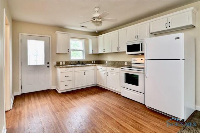 4134 Angola Rd, Toledo, OH 43615 - kitchen with white appliances, white cabinetry, light wood-style floors, and a ceiling fan