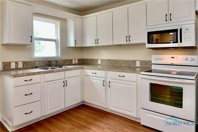 4134 Angola Rd, Toledo, OH 43615 - kitchen featuring white appliances, white cabinets, light wood-style floors, and light countertops