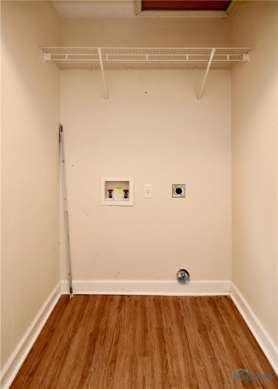 4134 Angola Rd, Toledo, OH 43615 - washroom featuring electric dryer hookup, washer hookup, and wood finished floors