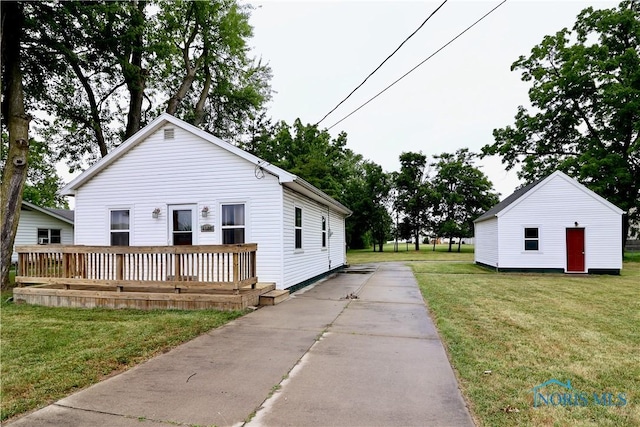 4134 Angola Rd, Toledo, OH 43615 - view of front of house with a front yard, a wooden deck, and driveway