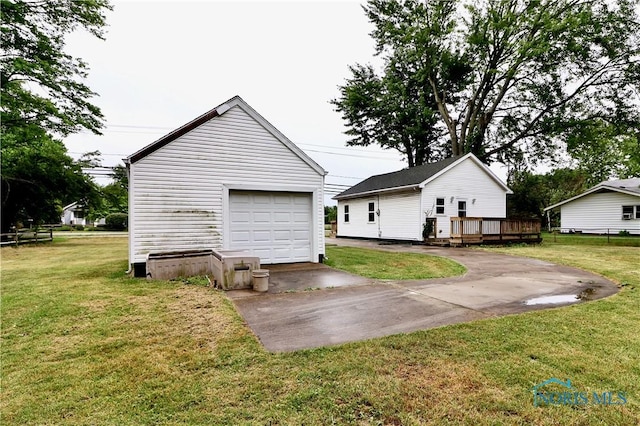 4134 Angola Rd, Toledo, OH 43615 - rear view of property with a deck, an outdoor structure, a detached garage, a yard, and driveway