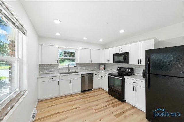1118 Michigan Ave, Maumee, OH 43537 - kitchen with black appliances, light countertops, backsplash, white cabinets, and recessed lighting