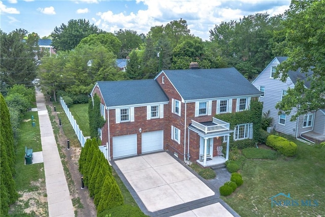 2403 Hempstead Rd, Ottawa Hills, OH 43606 - view of front of home with concrete driveway, brick siding, a garage, and a chimney