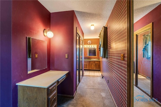 6608 Inglewood Dr, Holland, OH 43528 - hall featuring a textured ceiling and carpet flooring