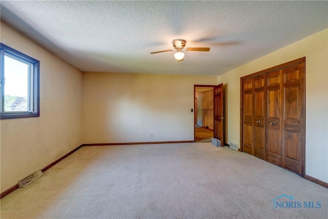 6608 Inglewood Dr, Holland, OH 43528 - unfurnished bedroom with carpet floors, a closet, a ceiling fan, and a textured ceiling