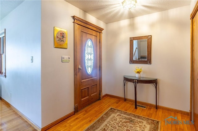 312 W Dudley St, Maumee, OH 43537 - foyer with light wood finished floors and a textured ceiling