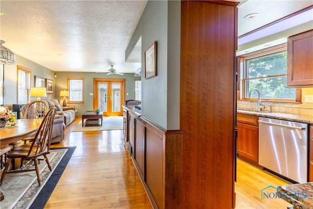 312 W Dudley St, Maumee, OH 43537 - kitchen featuring stainless steel dishwasher, a textured ceiling, open floor plan, light wood-type flooring, and a ceiling fan