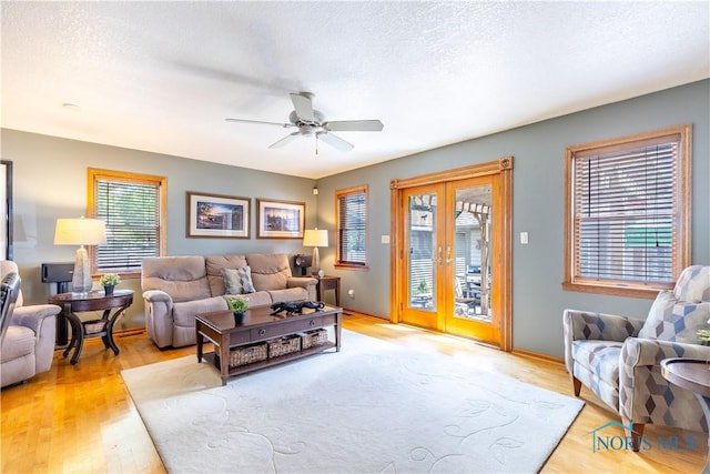312 W Dudley St, Maumee, OH 43537 - living room with light wood-style floors, french doors, a ceiling fan, and a textured ceiling