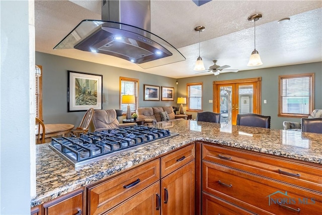 312 W Dudley St, Maumee, OH 43537 - kitchen with stainless steel gas cooktop, extractor fan, open floor plan, a textured ceiling, and brown cabinets