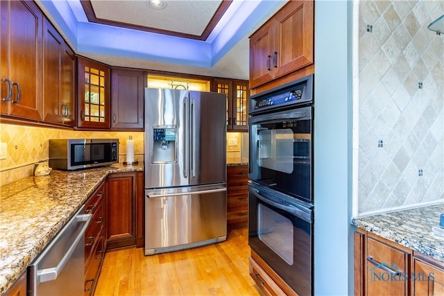 312 W Dudley St, Maumee, OH 43537 - kitchen with stainless steel appliances, light wood finished floors, glass insert cabinets, and light stone countertops