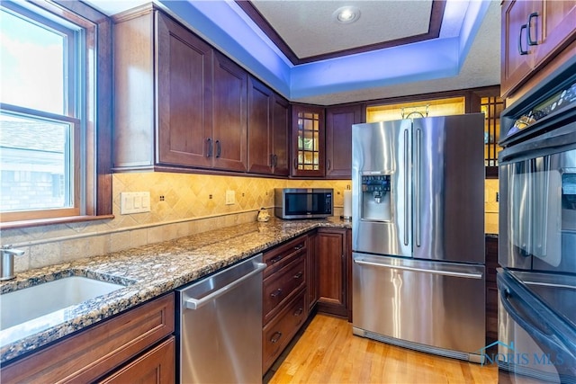 312 W Dudley St, Maumee, OH 43537 - kitchen featuring stainless steel appliances, stone countertops, a raised ceiling, glass insert cabinets, and decorative backsplash