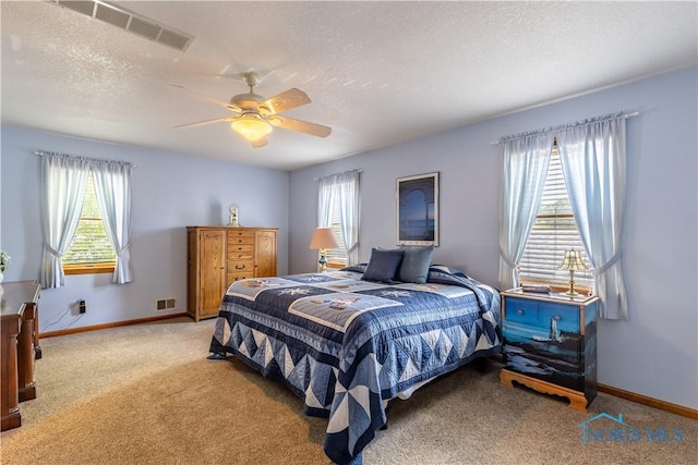 312 W Dudley St, Maumee, OH 43537 - bedroom featuring multiple windows, light colored carpet, a textured ceiling, and a ceiling fan