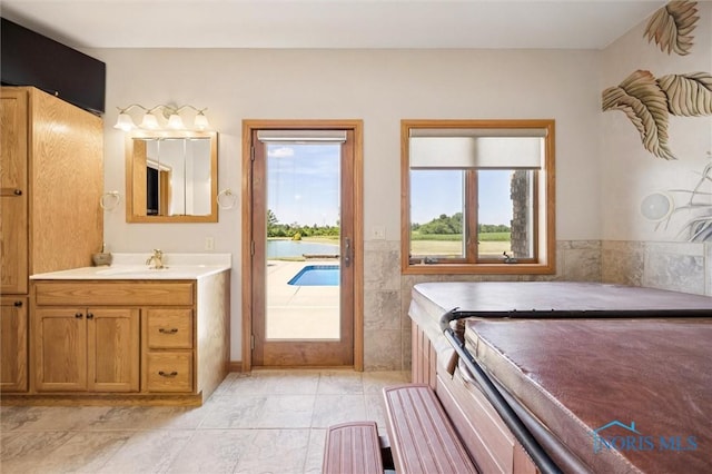586 N State Route 587, Fostoria, OH 44830 - full bathroom featuring vanity, a bathtub, and marble look tile flooring