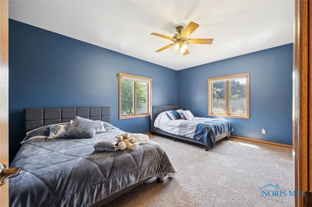 586 N State Route 587, Fostoria, OH 44830 - carpeted bedroom with baseboards and a ceiling fan