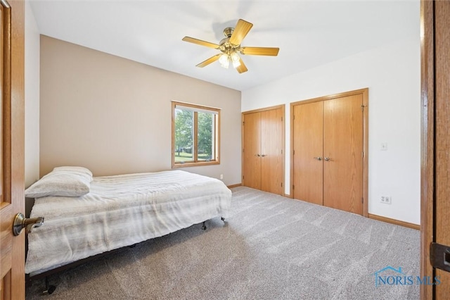 586 N State Route 587, Fostoria, OH 44830 - bedroom featuring multiple closets, carpet flooring, and ceiling fan
