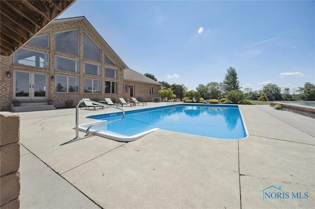 586 N State Route 587, Fostoria, OH 44830 - outdoor pool with a patio and french doors