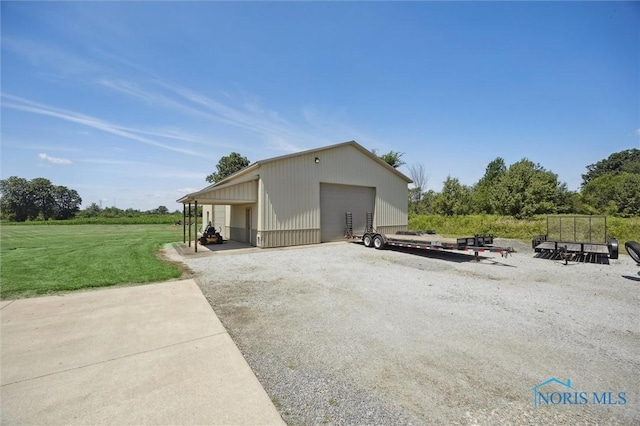 586 N State Route 587, Fostoria, OH 44830 - view of side of home featuring a garage, an outbuilding, and a yard