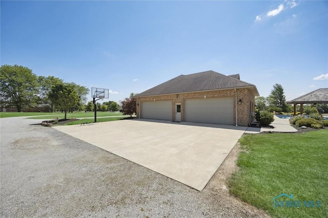 586 N State Route 587, Fostoria, OH 44830 - view of property exterior featuring driveway, a yard, brick siding, and a garage