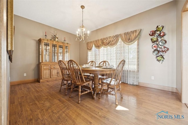 586 N State Route 587, Fostoria, OH 44830 - dining space featuring a chandelier and wood finished floors