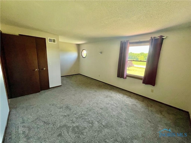 17988 Rd 156, Paulding, OH 45879 - unfurnished bedroom featuring a textured ceiling and carpet floors