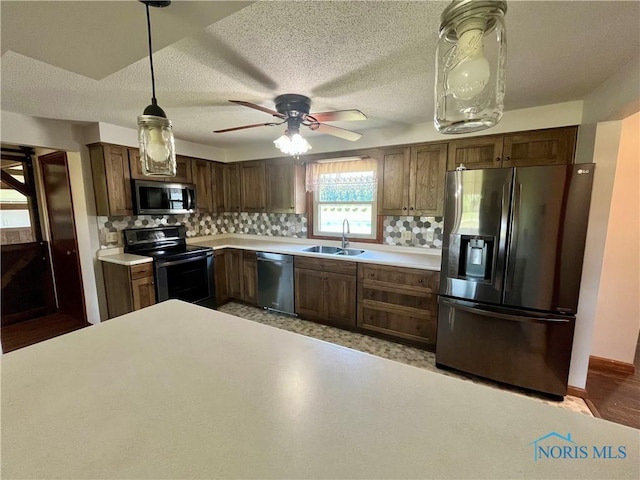 17988 Rd 156, Paulding, OH 45879 - kitchen with stainless steel appliances, light countertops, backsplash, decorative light fixtures, and ceiling fan