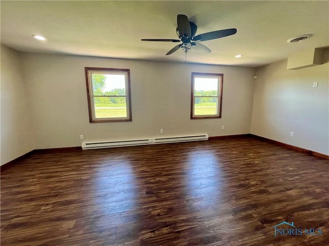 17988 Rd 156, Paulding, OH 45879 - unfurnished room featuring baseboard heating, plenty of natural light, dark wood-style flooring, ceiling fan, and recessed lighting