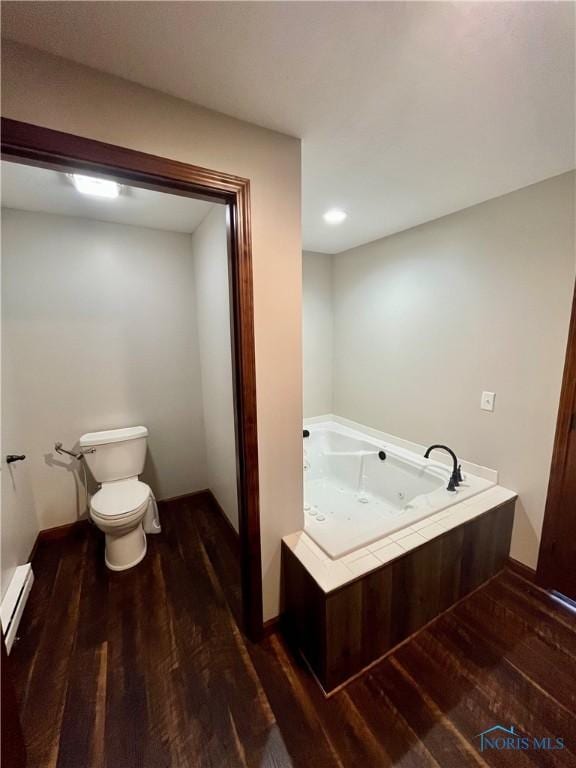 17988 Rd 156, Paulding, OH 45879 - bathroom featuring wood finished floors, a baseboard radiator, a whirlpool tub, and recessed lighting