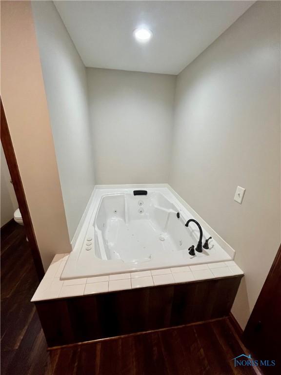 17988 Rd 156, Paulding, OH 45879 - full bathroom with wood finished floors and a tub with jets