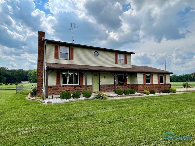 17988 Rd 156, Paulding, OH 45879 - view of front of property featuring a chimney, brick siding, a front yard, and a porch