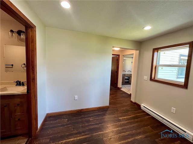 17988 Rd 156, Paulding, OH 45879 - hallway featuring a baseboard heating unit, dark wood-style floors, and recessed lighting