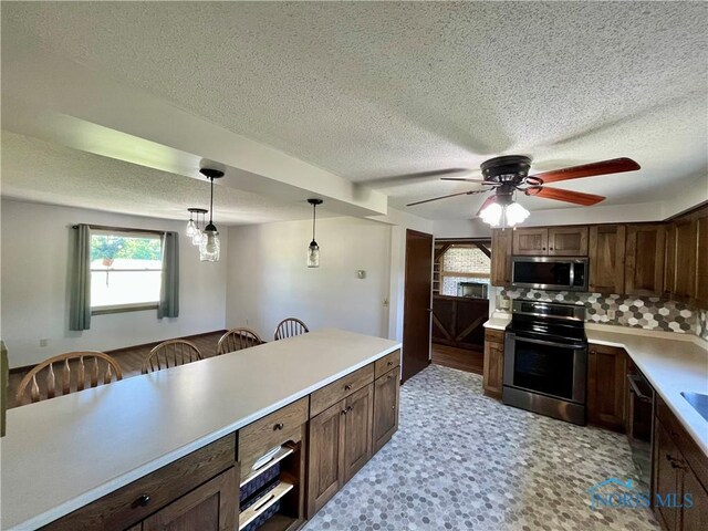 17988 Rd 156, Paulding, OH 45879 - kitchen with appliances with stainless steel finishes, plenty of natural light, light countertops, a textured ceiling, and a ceiling fan