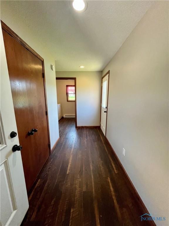 17988 Rd 156, Paulding, OH 45879 - corridor featuring dark wood-style flooring and baseboard heating