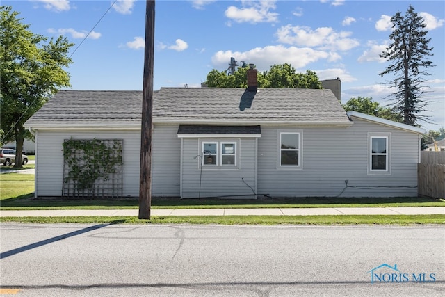 18735 Wall St, Tontogany, OH 43565 - view of side of home featuring a chimney and roof with shingles