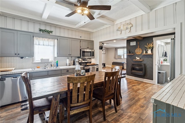 18735 Wall St, Tontogany, OH 43565 - dining room with dark wood-style flooring, a ceiling fan, coffered ceiling, beam ceiling, and wooden walls