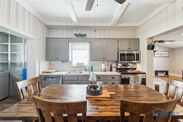 18735 Wall St, Tontogany, OH 43565 - kitchen with appliances with stainless steel finishes, gray cabinetry, a ceiling fan, and backsplash