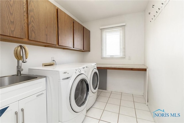 6842 Shieldwood Rd, Toledo, OH 43617 - washroom with cabinet space, separate washer and dryer, and light tile patterned floors