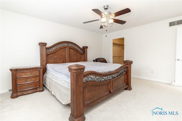 6842 Shieldwood Rd, Toledo, OH 43617 - bedroom featuring light carpet, a walk in closet, a ceiling fan, and a closet