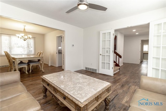6842 Shieldwood Rd, Toledo, OH 43617 - living room featuring a ceiling fan, a chandelier, wood finished floors, and stairway